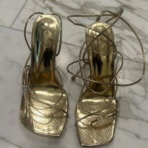 Gold heels. Wrap around ankle. Open toe. Never worn.